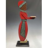 A figural painted wood dumb waiter. Height 77cm.