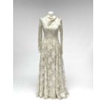A 1950s wedding dress, duchess satin overlaid with cotton lace, approximate size 10.Condition