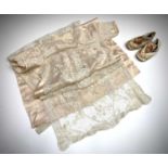 An early 20th century pink satin and lace christening gown, together with a pair of babies shoes