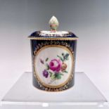 A Chelsea Derby pomade pot and cover, circa 1770, the blue ground with gilt bordered well painted