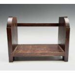 A Glasgow School Arts and Crafts mahogany book trough, the end panels carved with Mackintosh style