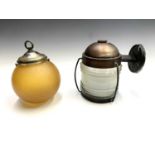 An exterior lamp, of maritime form, the metal mounts with copper finish and moulded glass shade,