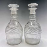 A pair of 19th century cut glass decanters, with faceted triple ring necks above hobnail cut banding