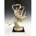 A Guiseppe Armani Capodimonte Florence figure group modelled as a pair of ballet dancers mid jete,