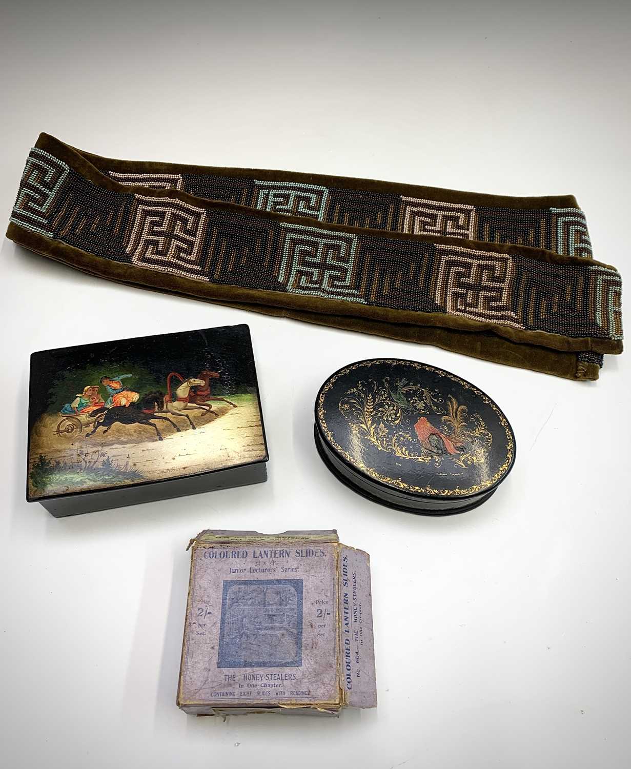 A Russian lacquer box, painted with a troika scene, width 15.5cm, together with a similar oval