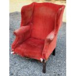 A Georgian mahogany framed wing back armchair (a/f). Height 99cm, width 75.5cm, depth 87cm.