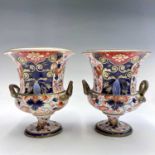 A pair of Derby campana form urns, circa 1820, painted and gilt decorated with a Japan pattern,