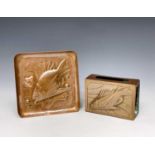 A Newlyn copper matchbox holder, repousse decorated with a fish, length 7.4cm, together with a small