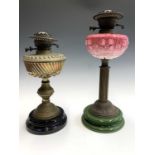 A Victorian pink opaque glass and brass oil lamp, height 46cm, and another brass example (2)