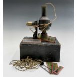 A late 19th century tin plate and brass magic lantern by Ernst Plank, overall height 27cm, contained