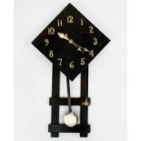An Arts and Crafts style stained oak wall clock, with lozenge shape dial and brass Arabic