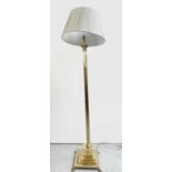 A brass Corinthian column standard lamp, the square stepped base with four paw feet, height 148cm.