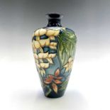 A Moorcroft Collector's Club 'Wisteria' pattern vase, designed by Phillip Gibson, painted and