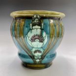 A Minton Secessionist jardiniere, the turquoise, purple and green ground tube lined ad decorated