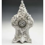 A 19th century French porcelain cased mantel clock by Vion & Baury, surmounted by a shepherdess,