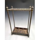 A late Victorian brass eight-section stick stand, with turned supports and painted metal drip