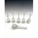 Six assorted George III glass toddy lifters, some with facetted stems and collars, the largest