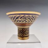 A Mary Rich studio porcelain stemmed bowl, the blue ground gilt decorated in a scale effect,