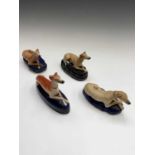 A Staffordshire pottery greyhound pen holder, 19th century, width 15.5cm, together with three