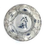 A Bristol Delft plate, circa 1770, painted in blue with Chinese temples on a manganese cracked ice