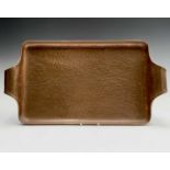 An Arts and Crafts planished copper tray, possibly Newlyn. 27.5 x 52.5cm overall.