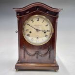 An Edwardian mahogany bracket clock, in the Regency taste, the white painted dial inscribed
