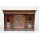 A Continental walnut credenza, 19th century, with central carved panel door flanked by columns and