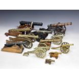 A collection of thirteen brass and cast metal cannon ornaments, various sizes, the largest 31cm