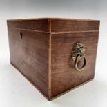 A late George III partridgewood and crossbanded tea caddy with twin lion mask handles and divided