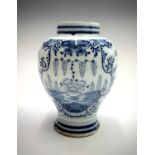 A late 18th century Delft tin glazed vase, painted with floral decoration in blue. Height 15.5cm.