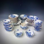 A Coalport 'Blue Dragon' pattern tea service with gold rim, comprising milk jug, sugar bowl,
