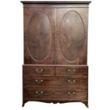 A George III mahogany linen press, the upper section with two oval rosewood banded panel doors,