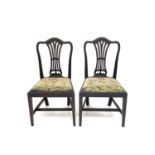 A pair of George III mahogany dining chairs, in the Chippendale style, with pierced vase splats, the