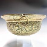 A Victorian embossed brass bowl, decorated with bands of running wave and floral decoration, a