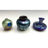 Three Norman Stuart Clarke iridescent glass small bud vases, height of largest 8cm.