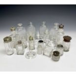 A large collection of glass lidded condiment bottles, some with stoppers.