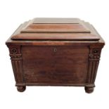 A William IV mahogany sarcophagus shaped wine cooler. the angles with applied mouldings and raised