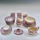 An early 19th century Staffordshire pink lustreware tea service with strawberry decoration
