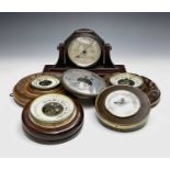 A late Victorian walnut aneroid barometer, diameter 18cm, another similar barometer, a bakelite