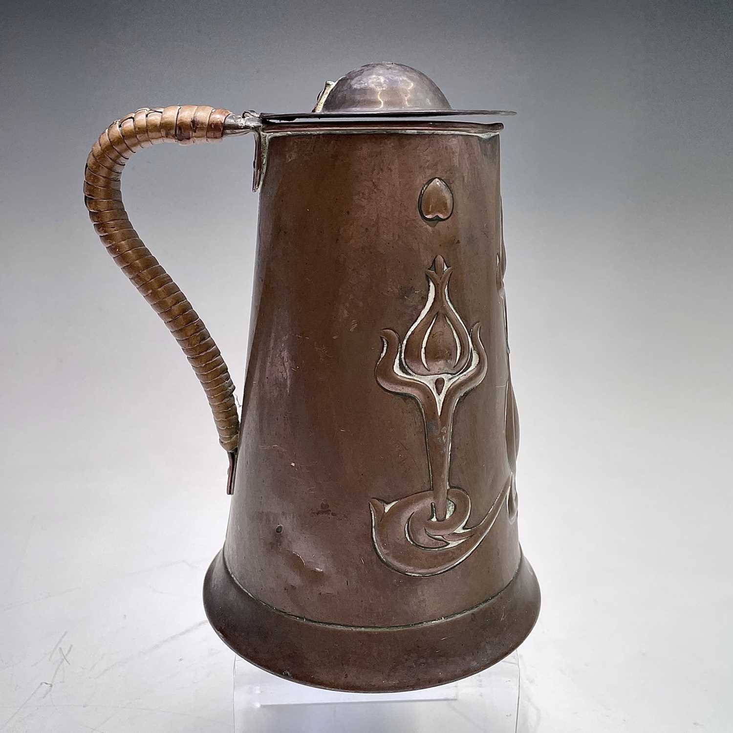An Arts and Crafts copper lidded jug, by Joseph Sankey & Son, of tapered form, embossed with - Image 2 of 5