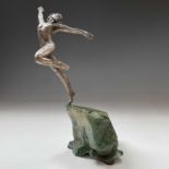 A bronzed figure of a dancing male, on green stone base, with an applied signature plaque for