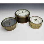A Shortland Bowen brass cased aneroid barometer, mid 20th century, diameter 12cm, together with a