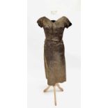 A circa 1950s 'Wishick & Webber Model' short-sleeved mid-length gold dress with black velvet bow