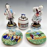 A pair of Italian slip-decorated pottery small wall plates decorated with bucolic scenes, diameter