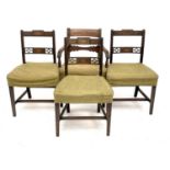 A set of three Regency mahogany and shell inlaid dining chairs, raised on reeded square tapering