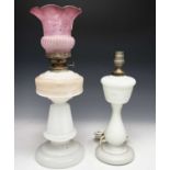 Two white opaque glass oil lamps, one converted, one with etched cranberry shade (2)Condition