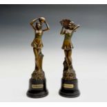 A pair of Art Deco spelter female figures, 'Morning' and 'Evening', raised on bakelite socles.