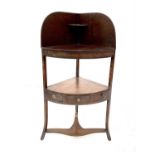 A late George III mahogany corner washstand, with ebony stringing, the lower tier fitted a single