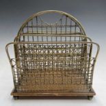 A late 19th/early 20th century brass wirework and oak four-division magazine rack. Height 39cm,