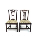 A pair of George III mahogany dining chairs of Chippendale design, with drop-in seats on square